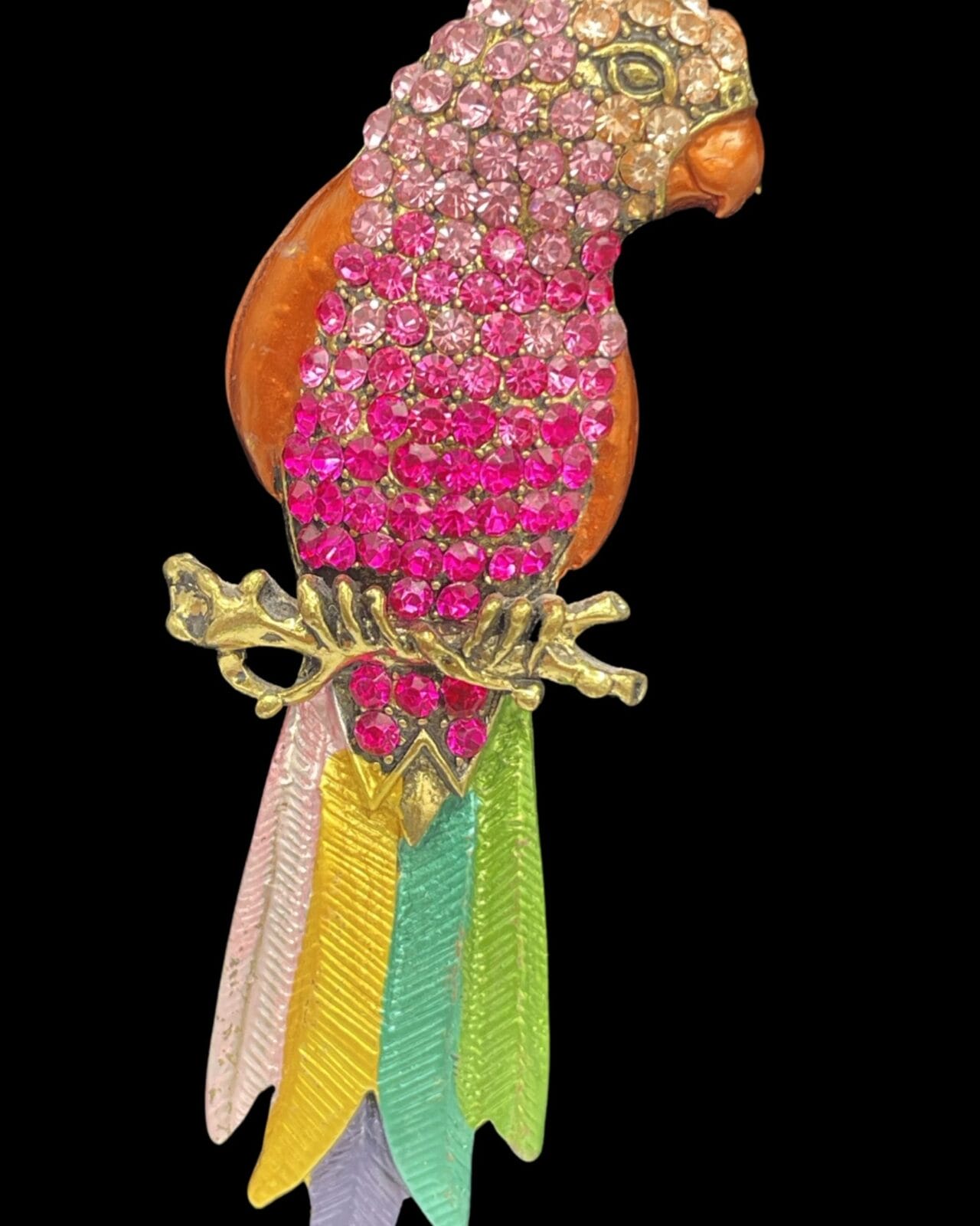 An elegant pink rhinestone parrot pendant necklace with silver chain, with feathers.
