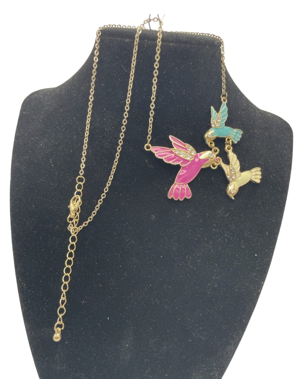 An Enchanting Enamel Trio of Hummingbirds Necklace on a mannequin.