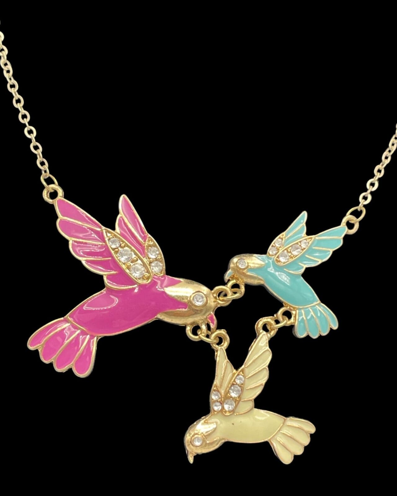Three Enchanting Enamel Trio of Hummingbirds Necklaces on a gold chain necklace.